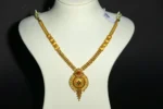 Woman wearing a Gold Chakra Pendant Necklace